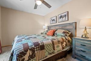 a bedroom with a bed and a dresser at Coy Cottage - NEAR OKTOBERFEST! Calm & quite location within minuets of the heart of town! in Big Bear City