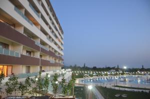 a large apartment building with a swimming pool at night at Hattusa Vacation Thermal Club Erzin in Erzin