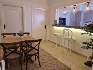 a dining room with a wooden table and chairs at Partial Nile View 2 Bedroom Appartment in Zamalek Cairo Newly Renovated in Cairo