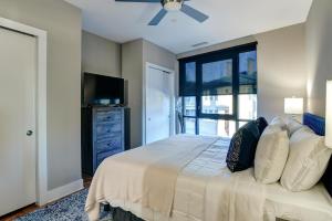 a bedroom with a bed with a tv and a window at 145 Biltmore Avenue Condo 541B0E in Asheville