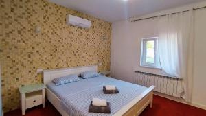 a bedroom with a bed with two towels on it at Fresh Accommodation in Rădăuţi