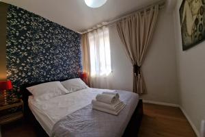 sypialnia z łóżkiem i ręcznikami w obiekcie Lux Apartment Art w Polanicy Zdroju