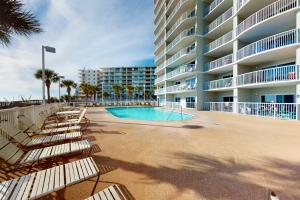 a swimming pool in front of a large apartment building at Tradewinds #1208 in Orange Beach