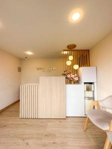 a kitchen with a white refrigerator and a counter at Hotel Santa Elena Norte in Tunja