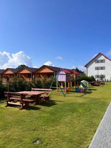 a park with a picnic table and a playground at Ośrodek Polny Kamyk in Wicie