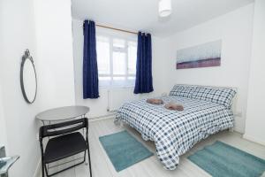 a bedroom with a bed with a teddy bear on it at Nice Rooms near Shoreditch in London