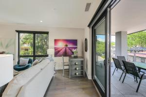 a living room with a couch and a table at Supreme Downtown Condo in Asheville