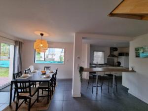 a dining room and kitchen with a table and chairs at VILLA ROSA PARK in Guipavas +13 photos