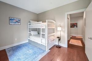 a bedroom with two bunk beds and a hallway at Supreme Downtown Condo in Asheville