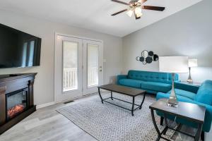 a living room with a blue couch and a fireplace at South Asheville Townhome 12 A in Arden