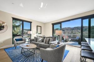 a living room with a couch and chairs and windows at 145 Biltmore Ave A New Luxury Condo 541E0D in Asheville
