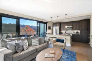 a living room with a couch and a kitchen at 145 Biltmore Ave A New Luxury Condo 541E0D in Asheville