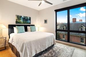 a bedroom with a bed and a large window at 145 Biltmore Ave A New Luxury Condo 541E0D in Asheville