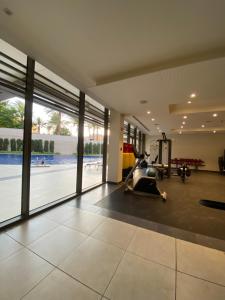 a gym with a treadmill and a swimming pool at aladnan Chalet alraha village in Aqaba