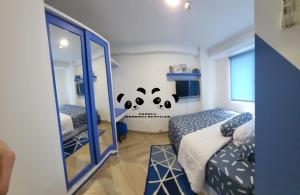 a bedroom with two beds and a mirror at Apartment Kalibata City by PanBul in Jakarta