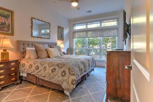 a bedroom with a bed and a large window at 55 South Market Condo 209 in Asheville