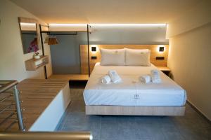 a bedroom with a large bed with towels on it at Fay Suites in Flogita