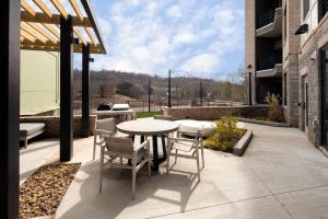 a patio with a table and chairs on a building at 55 South Market Condo 104 in Asheville