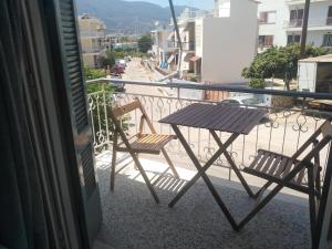 a table and two chairs sitting on a balcony at Elinas Room in Poros
