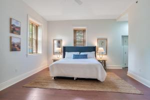 a bedroom with a bed and two windows at 8 Village Lane 100 in Asheville