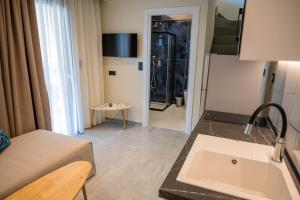 a kitchen and living room with a couch and a refrigerator at Fay Suites in Flogita +58 photos