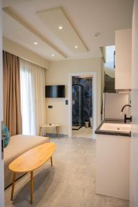 a kitchen and living room with a couch and a table at Fay Suites in Flogita