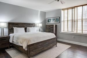 a bedroom with a large bed and two windows at 8 Village Lane 200 in Asheville