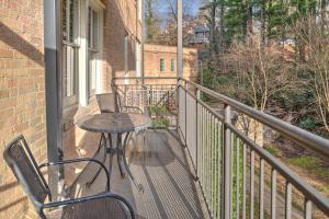 a patio with a table and chairs on a balcony at 8 Village Lane 200 in Asheville