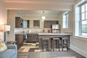 a kitchen with a large island with bar stools at Historic King James Unit 1 in Asheville