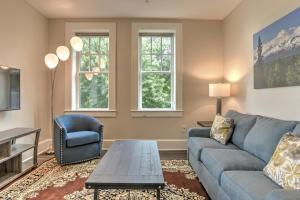 a living room with a blue couch and a chair at Historic King James Unit 1 in Asheville