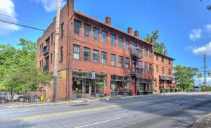 a large red brick building on a city street at Historic King James Unit 1 in Asheville