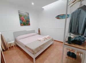 a bedroom with a bed and a painting on the wall at Appartamento Borgonuovo in Gallipoli +21 photos