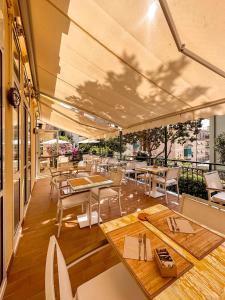 a restaurant with tables and chairs on a patio at Hotel Villa Anita in Santa Margherita Ligure