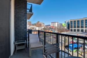 a balcony with a chair and a view of the city at 45 Asheland Avenue Unit 405 in Asheville