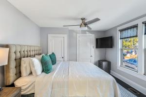 a bedroom with a large bed and a ceiling fan at 237 East Chestnut St in Asheville