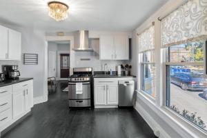 a kitchen with a stove top oven next to a window at 237 East Chestnut St in Asheville +5 photos