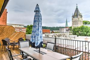 a table and chairs on a balcony with a view of a city at Magnificent S and W Building Condo in Asheville