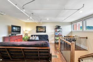a living room with a couch and a tv at Magnificent S and W Building Condo in Asheville