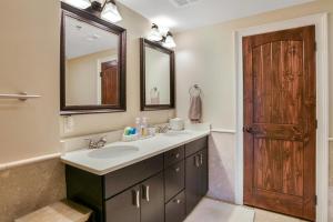 a bathroom with a sink and a mirror at Magnificent S and W Building Condo in Asheville +21 photos