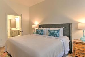 a bedroom with a large bed with blue pillows at 55 South Market Condo 204 in Asheville