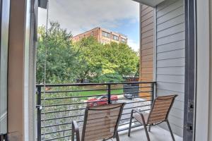 a balcony with two chairs and a table at 55 South Market Condo 204 in Asheville