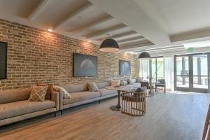 a living room with couches and a brick wall at 55 South Market Condo 203 in Asheville