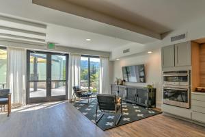 a living room with a kitchen with a sliding glass door at 55 South Market Condo 203 in Asheville