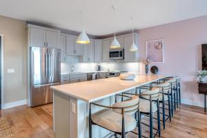 a kitchen with a large island with bar stools at Outstanding Luxury Downtown Condo in Asheville