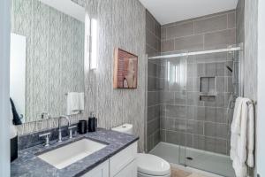 a bathroom with a sink and a toilet and a shower at Outstanding Luxury Downtown Condo in Asheville +10 photos