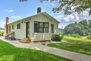 a tiny house in the middle of a field at Dogwood Farmhouse in Candler