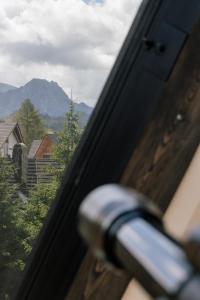 a close up of a door with a view of a mountain at Slow Tatry Boutique Resort&SPA in Zakopane