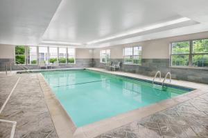 a swimming pool with blue water in a building at Residence Inn Boston Franklin in Franklin