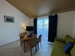 a living room with a table and a couch at Apartments Marija in Lastovo