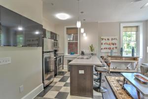 a kitchen with stainless steel appliances and a checkered floor at Historic King James Unit 5 in Asheville +10 photos